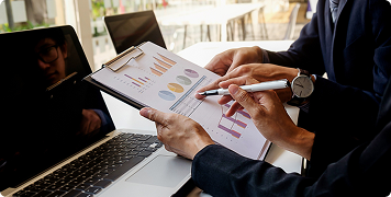 Rectangle 13472 Business professionals analyzing website data and charts for aesthetic clinic growth.